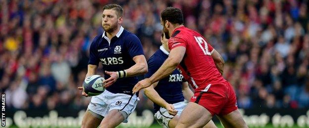 Jamie Roberts moves in to challenge Scotland's Finn Russell