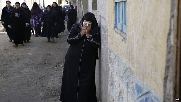 Relatives of Egyptian Coptic Christian workers mourn in Al-Our. 15 February 2015