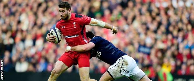 Scotland's Alex Dunbar tries to halt the progress of Alex Cuthbert