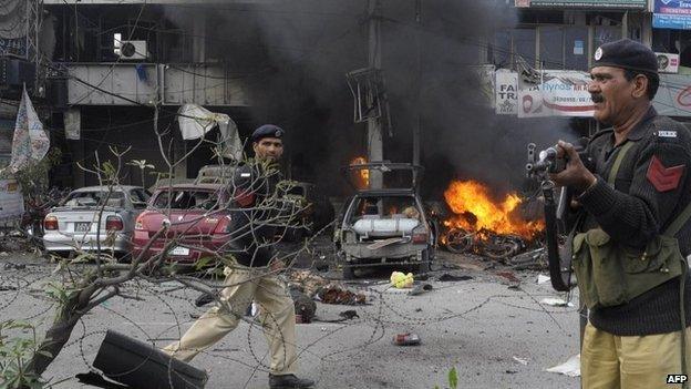 Pakistani policemen arrive at the site of a bomb explosion in Lahore on 17 February 2015.