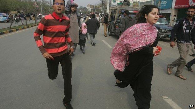 People run following a bombing in Lahore, Pakistan, Tuesday 17 February 2015