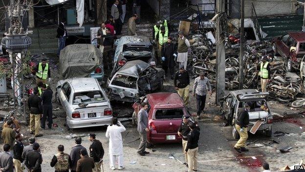 Pakistani security officials inspect the scene of a suicide bomb attack that targeted a Police accommodation in Lahore, Pakistan, 17 February 2015.