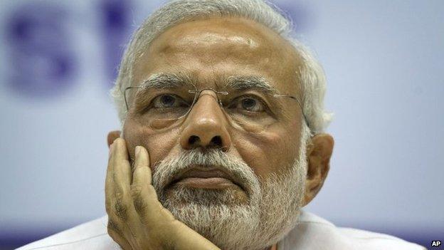 Indian Prime Minister Narendra Modi, listens to a speaker as he attends a function to the mark recent canonization of two Indians by the Vatican in New Delhi, India, Tuesday, Feb. 17, 2015.