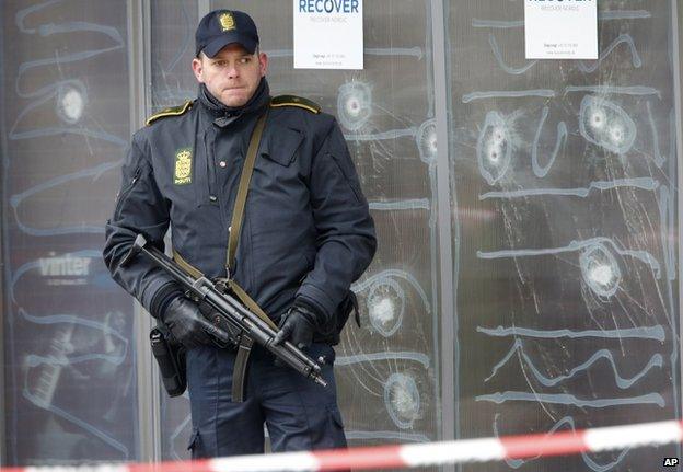 A police officer stands in front of the cultural centre where a gunman killed one person in Copenhagen, Denmark. 16 February 2015