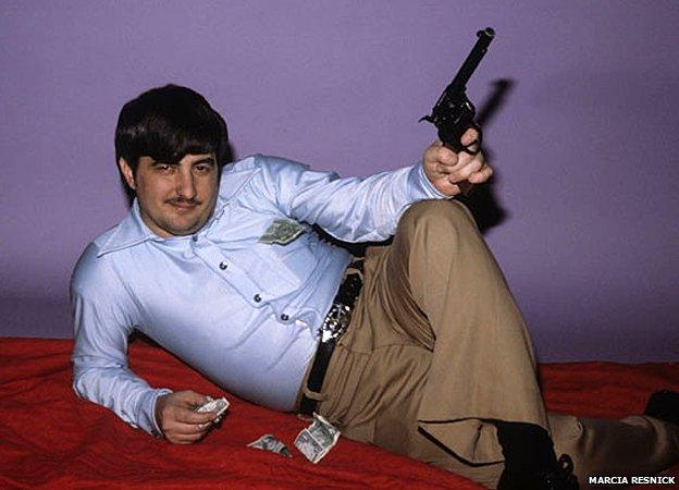 John Wojtowicz poses with gun and money
