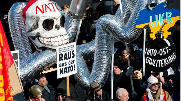 Demonstrators take part in a protest titled "There is no Peace with NATO" in front of the venue of the 51st Munich Security Conference in Germany on February 7, 2015.