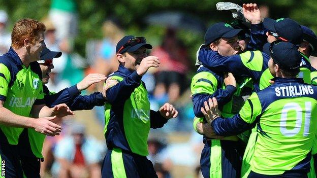 Ireland players celebrate taking the wicket of West Indies player Chris Gayle