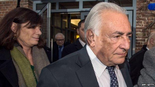 Former IMF chief Dominique Strauss-Kahn (C), flanked by his lawyer Frederique Beaulieu (L), leaves his hotel on February 17, 2015 in Lille, France