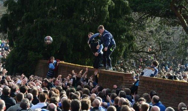 The ball breaks from the hug during the annual Shrovetide football match in Ashbourne, 17 February 2015