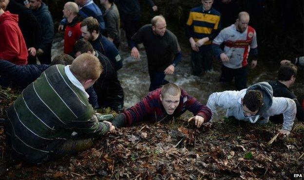 Team members scramble from a ditch in Ashbourne, 17 February 2015