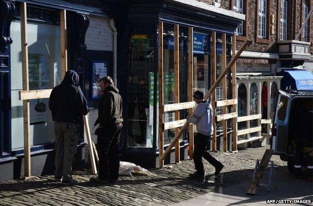 Workmen board up a building society