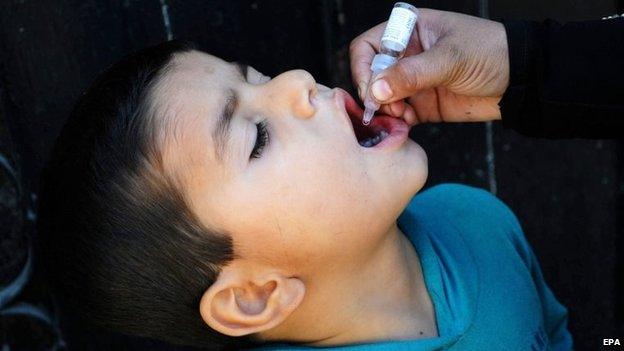 A health worker administers the Polio vaccine to a child in Karachi, Pakistan on 27 January 2015.