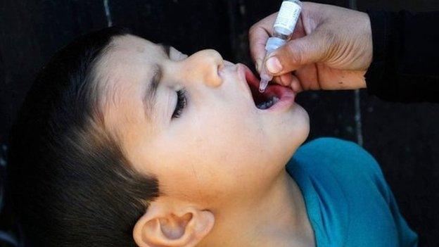 A health worker administers the Polio vaccine to a child in Karachi, Pakistan on 27 January 2015.