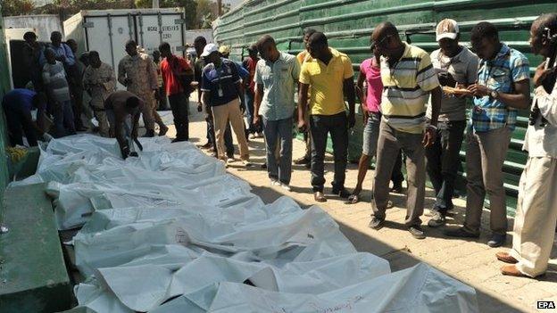 Relatives try to identify the bodies of victims at the morgue of Port-Au-Prince, Haiti on 17 February 2015