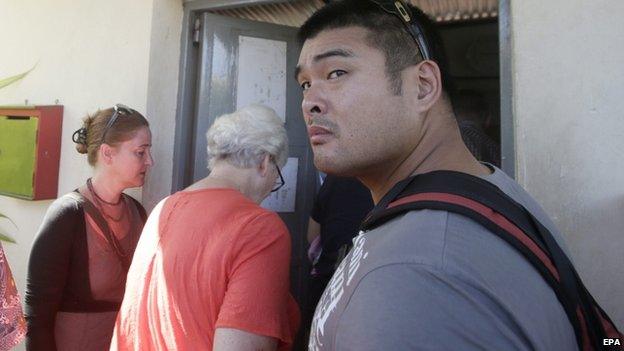 Australian Michael Chan (R), the brother of death-row prisoner Andrew Chan, arrives for visiting Andrew at Kerobokan Prison in Bali, Indonesia