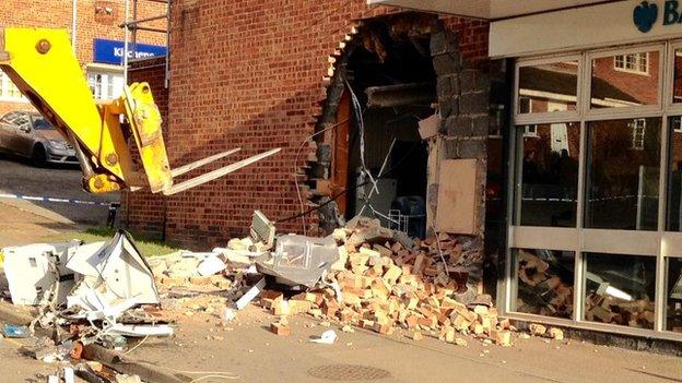 The digger outside the branch of Barclays