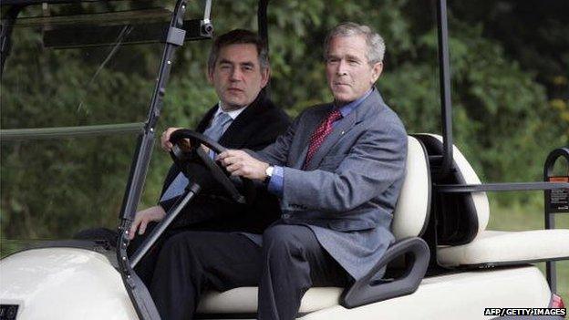 US President George W. Bush drives Britain's Prime Minister Gordon Brown in a golf cart after his arrival at Camp David, Maryland, 29 July 2007.