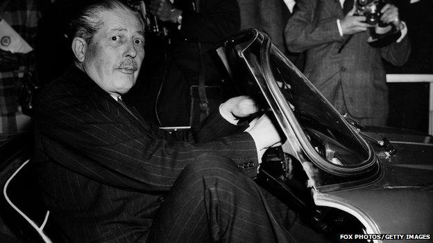 Prime Minister Harold MacMillan squeezed into a very small car which was on display at the Earls Court motor show in 1957