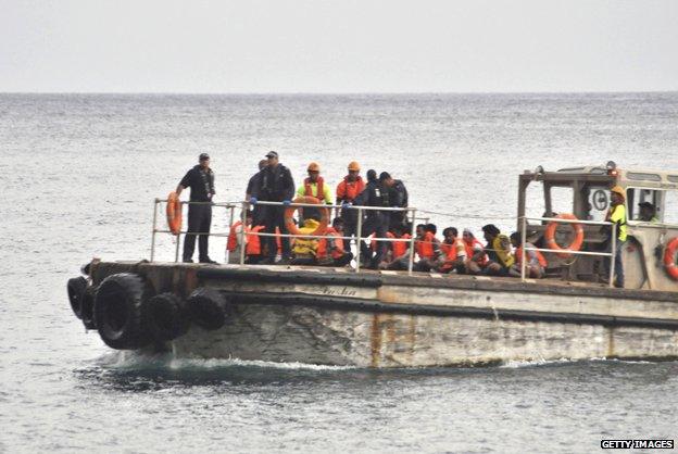 Rescue ship takes asylum seekers to Christmas Island in 2012