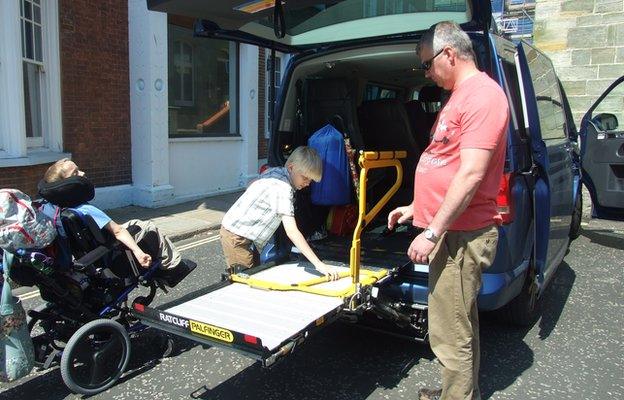 Alfie getting into his wheelchair accessible vehicle