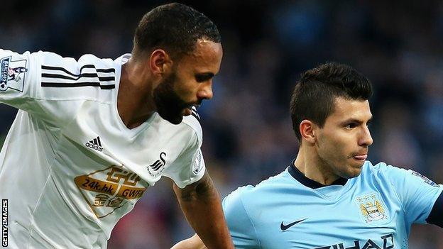 Swansea City's Kyle Bartley (left) with Manchester City's Sergio Aguero