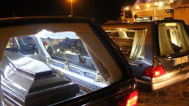 The coffins with the bodies of immigrants who died trying to reach the Italian coast arrive from Lampedusa on 11 February 2015 disembark in Porto Empedocle where they will be buried in cemeteries of the area.