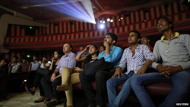 Cinema goers watch Bollywood movie "Dilwale Dulhania Le Jayenge" (The Big Hearted Will Take the Bride), starring actor Shah Rukh Khan, inside Maratha Mandir theatre in Mumbai December 12, 2014