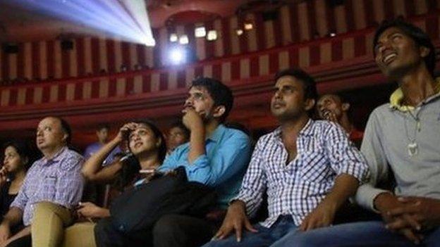 Cinema goers watch Bollywood movie "Dilwale Dulhania Le Jayenge" (The Big Hearted Will Take the Bride), starring actor Shah Rukh Khan, inside Maratha Mandir theatre in Mumbai December 12, 2014