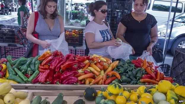 Shoppers buy vegetables at a local Farmers Market in Annandale, Virginia, 8 August 2013
