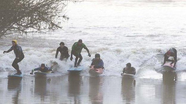 Surfers on the Severn Bore