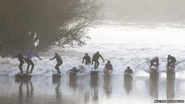 Surfers on the Severn Bore