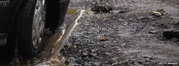 A car driving through a puddle