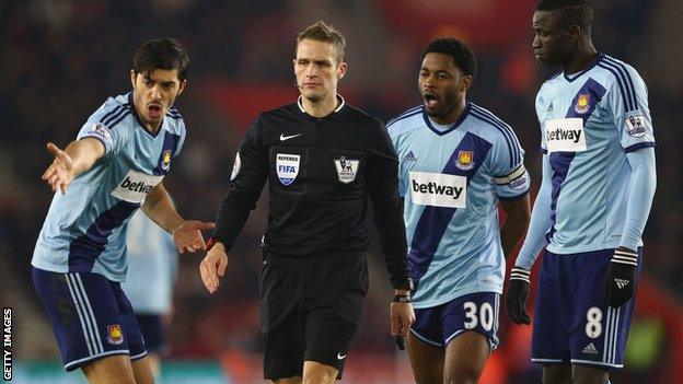 West Ham players protest to referee Craig Pawson