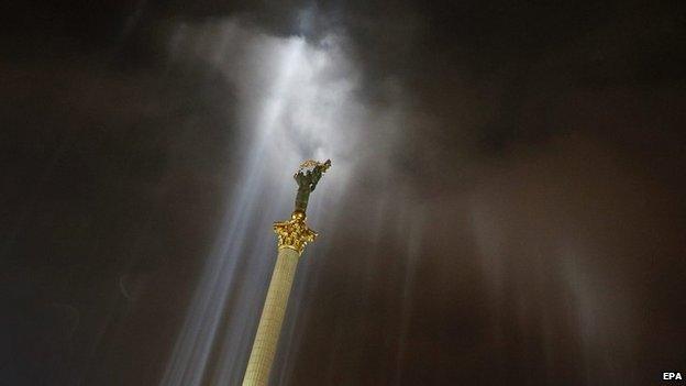 The statue of Goddess Berehynia is illuminated by lights placed where activists were killed in Independence Square in Kiev, Ukraine - 20 February 2015