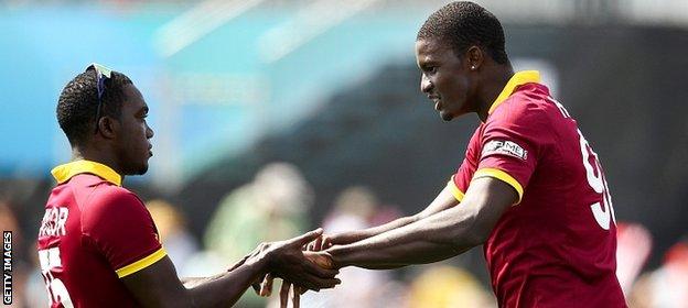 Jerome Taylor (L) and Jason Holder (R) of West Indies celebrate