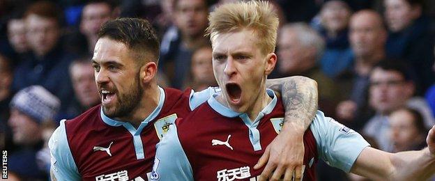 Burnley defender Ben Mee celebrates his side a point as he scores a header at Chelsea