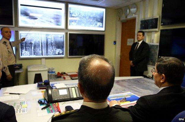 Turkish Prime Minister Ahmet Davutoglu (right) is briefed by the army in Ankara, 22 February