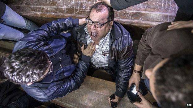 Relatives and supporters of Alaa Abdel Fattah react after the verdict in the Cairo courtroom - 23 February 2015