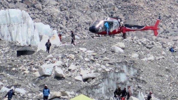 A Nepalese rescue helicopter lands at Everest Base Camp during rescue efforts following an avalanche that killed 16 Sherpas (April 2014)