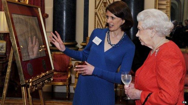 The Queen is shown a copy of the Magna Carta at Buckingham Palace by Dr Claire Breay