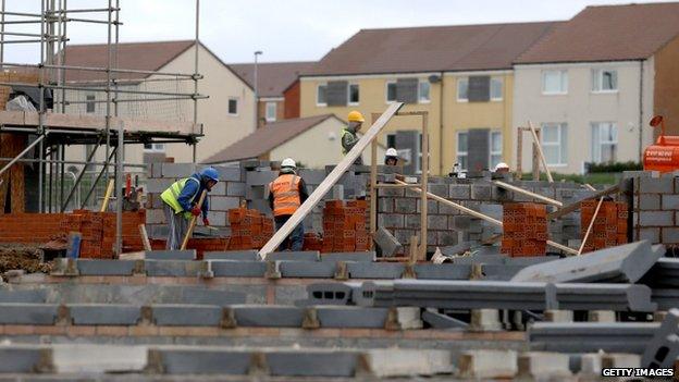 Builders constructing new houses