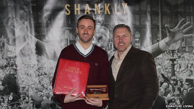 Bill Shankly's grandson Chris Shankly-Carline holding memorabilia with developer Lawrence Kenwright