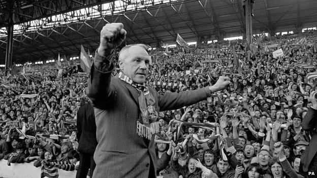 Bill Shankly turning towards the Kop end of Anfield, he gets an ovation from the fans who idolised him when Liverpool became League champions.