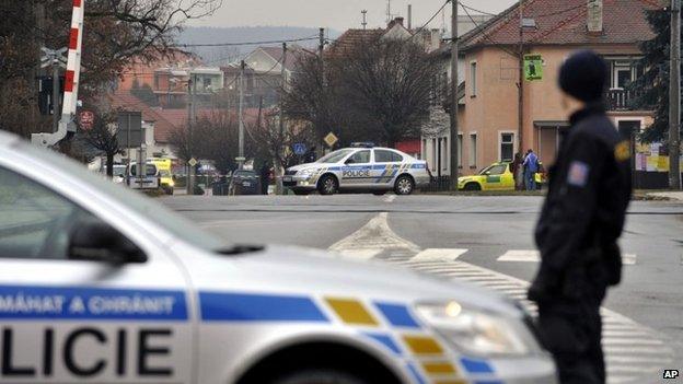 A police officer patrols near a restaurant where a gunman opened fire in Uhersky Brod, in the east of the Czech Republic, 24 Feb