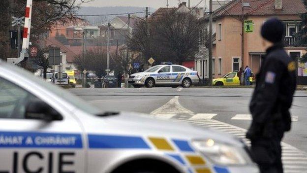 A police officer patrols near a restaurant where a gunman opened fire injuring at least one person in Uhersky Brod, in the east of the Czech Republic