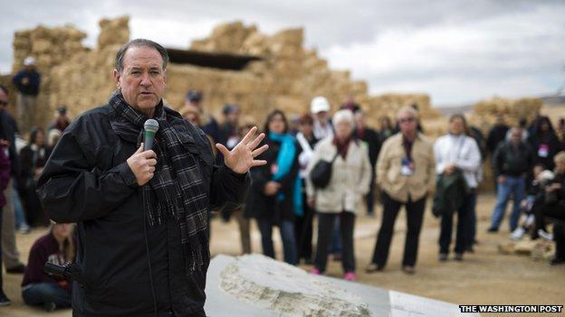 Mike Huckabee speaks to tourists in Israel.