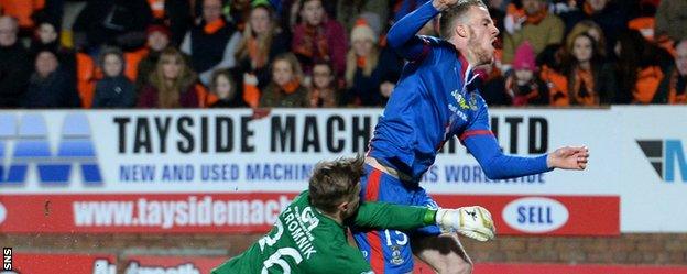 Marley Watkins is brought down by Dundee United goalkeeper Michal Szromnik early in the match