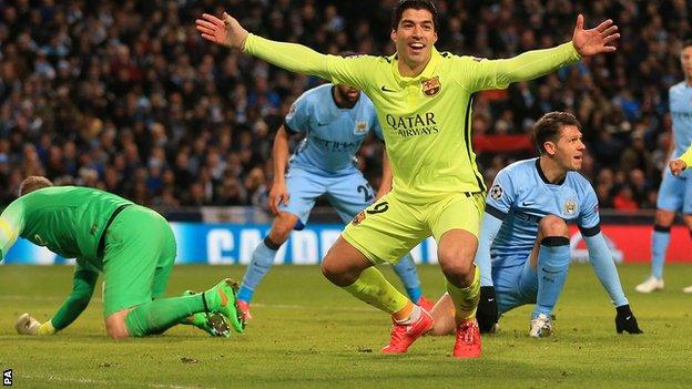 Luis Suarez celebrates scoring against Manchester City