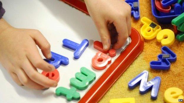 Child playing with letters