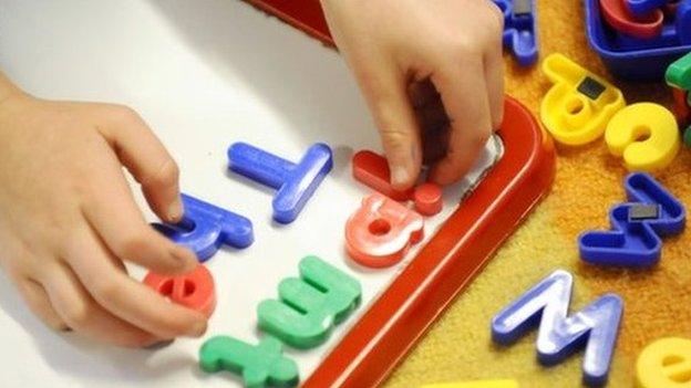 Child playing with letters